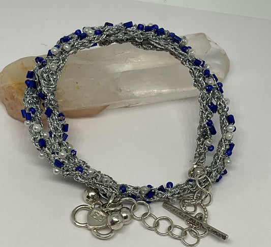 Bracelet woven in silver thread.
