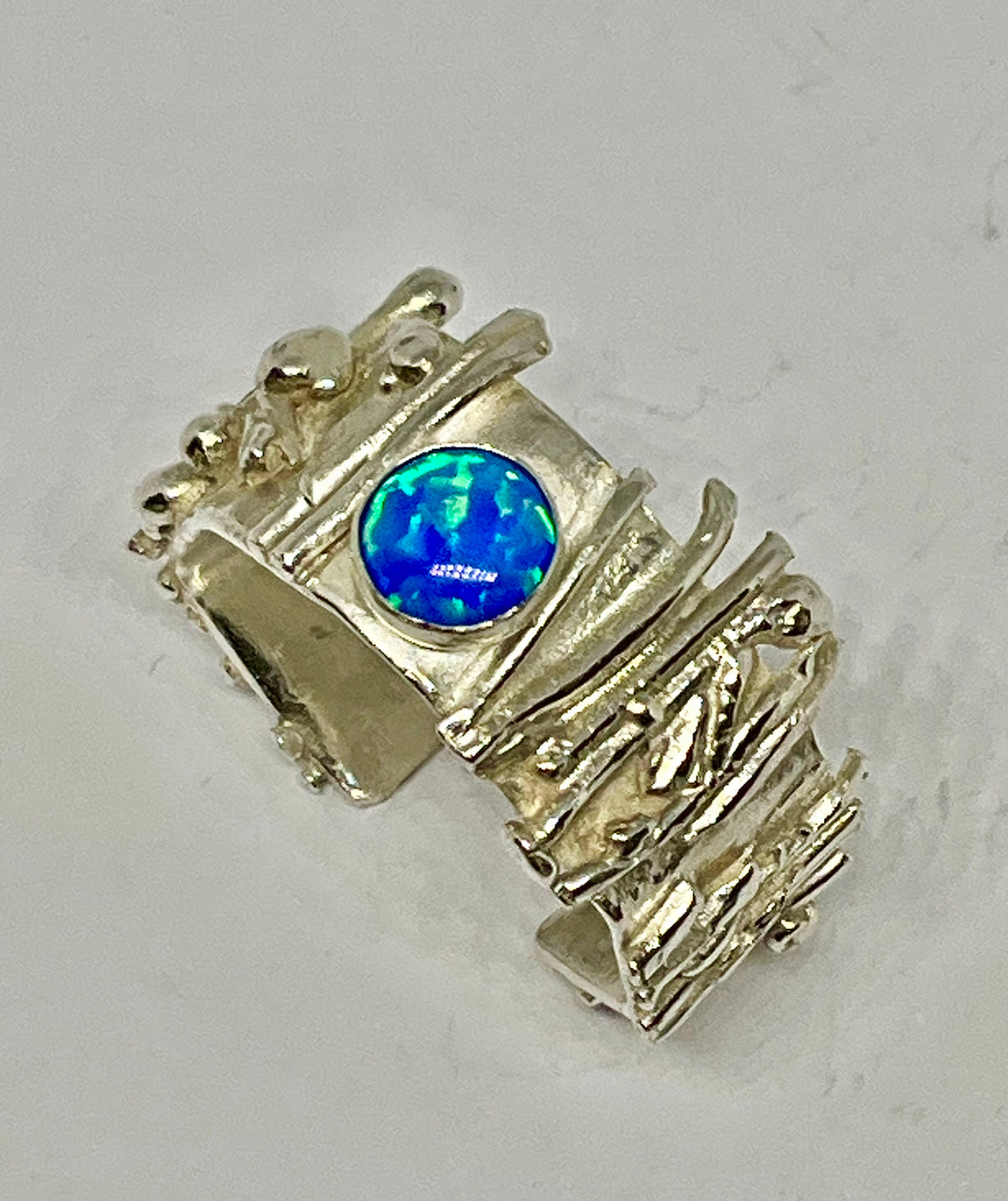Electric Blue Opal set in Botanical Inspired Ring Design